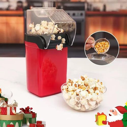 Measuring cup pouring popcorn kernels into the Popcorn Maker